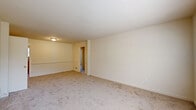 Located at 9010 Patterson Ave in Henrico, VA, this single-floor, three-bedroom, one-bathroom home offers a well-organized layout designed for comfortable everyday living. The living room is generously sized, finished with neutral-toned carpet and warm beige walls, and features a hallway connection that provides easy flow throughout the home. Natural light enters through blinds-fitted windows, giving the space a bright, welcoming atmosphere.

The kitchen is equipped with warm oak cabinetry, dark speckled countertops, a stainless steel sink, a gas range, and a full-size refrigerator. A convenient in-unit washer and dryer are tucked within a dedicated closet alcove in the kitchen area, adding practical value. Tile flooring runs throughout the kitchen.

The primary bedroom is notably spacious and features dual closets, offering ample storage. The two additional bedrooms are carpet-floored with windows that bring in natural light, each providing a comfortable and functional space. Three closets are distributed across the bedrooms to meet storage needs.

The bathroom is cleanly appointed with a wood-toned vanity, a mirrored medicine cabinet, tile surround, and a shower-tub combo. A hallway connects the bedrooms and bathroom, creating an efficient and cohesive floor plan throughout this practical Henrico residence.