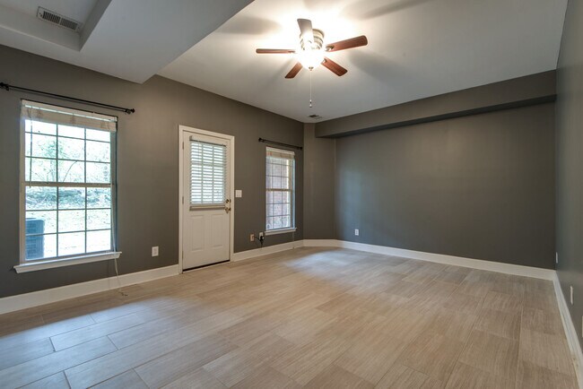 The downstairs bonus room has fresh paint and new tile with walk-out access to the covered patio. - 104 Carriage Ct.