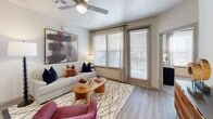 Located at 12479 Rojas Dr in El Paso, TX, this single-story, 2-bedroom, 2-bathroom home offers a thoughtfully designed layout with modern finishes throughout. The entrance opens into a hallway that connects the main living areas, with a dedicated laundry room featuring washer and dryer hookups and built-in shelving conveniently positioned off the corridor. The open-concept kitchen and dining area is a standout, showcasing white shaker cabinetry, granite countertops, a tile backsplash, stainless steel appliances, and a central island with bar seating illuminated by pendant lighting. The living room is bright and welcoming, with large windows and a sliding glass door that leads to a private patio, filling the space with natural light. Both bedrooms are carpeted and feature ceiling fans, while the spacious primary bedroom includes a walk-in closet. The two bathrooms are finished with granite-top vanities, wood-look flooring, and tiled tub-shower combinations. Two closets provide ample storage throughout the home. Light wood-look flooring flows through the main living areas, tying together the clean, contemporary aesthetic of this well-designed El Paso residence.
