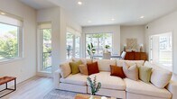 Located at 23 Rock Hill Rd in Bala Cynwyd, PA, this well-appointed 2-bedroom, 2-bathroom residence delivers a modern living experience across a single, efficiently organized floor. Light hardwood flooring runs throughout, complementing the clean, neutral palette that defines the interior aesthetic.

The open-concept living and dining area is a standout, featuring large windows and sliding glass doors that flood the space with natural light and provide direct access to a private balcony. From the balcony, residents enjoy views of the lush, tree-lined neighborhood streetscape as well as surrounding greenery. The kitchen is sleek and functional, outfitted with white cabinetry, a subway tile backsplash, stainless steel appliances, and ample counter space.

The spacious primary bedroom features oversized windows that invite abundant natural light and offer pleasant neighborhood views, along with a dedicated walk-in closet fitted with wire shelving for organized storage. The second bedroom is equally well-lit and comfortable. Both bathrooms are finished in a contemporary style; one includes a frameless glass walk-in shower with large-format tile surround and contrasting floor tile. Additional features include two hallways, a utility room, and recessed lighting throughout, contributing to the home's bright and modern ambiance.