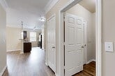 Located at 344 Murray Farm Dr in Fairview, TX, this single-story, three-bedroom, two-bathroom home offers a well-designed layout with a warm, neutral color palette throughout. Rich hardwood-style flooring flows through the main living areas, while plush carpet adds comfort to the bedrooms.

The open-concept living, dining, and kitchen area forms the heart of the home. The kitchen is outfitted with dark espresso cabinetry, granite-style countertops, a tile backsplash, stainless and black appliances, a double sink, and pendant and track lighting. A pantry provides additional storage. Large windows bring in ample natural light, and crown molding adds a refined touch.

Three well-sized bedrooms each feature carpeted floors, with the primary bedroom offering a generous walk-in closet with built-in wire shelving. The bedrooms are complemented by ceiling fans and windows with views of the outdoors. Four closets in total ensure excellent storage capacity throughout.

The bathrooms are finished with dark wood vanities, granite-style countertops, wood-look tile flooring, and a soaking tub with tile surround. A dedicated laundry room with side-by-side washer and dryer hookups and overhead shelving adds everyday convenience. A utility room and hallway complete this thoughtfully organized single-floor home.