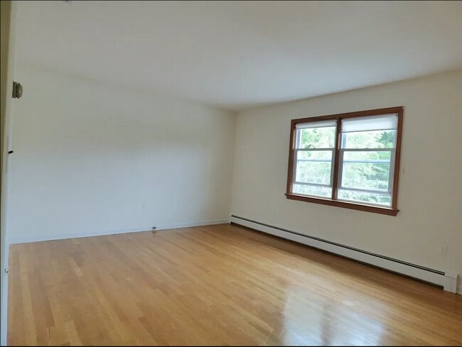 Sunny living room with hardwood floors. - 3 Grange St