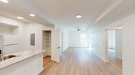 Located in New Orleans, LA, this 3-bedroom, 1-bathroom unit offers a clean, modern interior with a thoughtfully organized single-level layout. Light wood-tone flooring flows consistently throughout, creating a bright and cohesive look across every room. The open living area is spacious and sun-filled, benefiting from natural light that pours in through well-placed windows, with a ceiling fan overhead for added comfort. Adjacent to the living space, the galley-style kitchen features rich warm-toned wood cabinetry, light granite-style countertops, white appliances including a range and refrigerator, and a convenient built-in shelving pantry. A dedicated utility area with a washer is also accessible from the kitchen. The three bedrooms are each comfortably sized, with the primary bedroom offering a walk-in closet fitted with adjustable wire shelving and hanging rods. Additional bedrooms include standard closets with built-in shelving and ceiling fans. The full bathroom is well-finished with a soaking tub and shower combo, a wood-tone vanity with white countertop, and a bright vanity mirror with overhead lighting. Two hallways connect the space efficiently, and overall the unit maintains a clean, neutral palette ideal for a variety of furnishing styles.