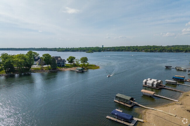 A boat comes into the bay beside a lake home in Prior Lake.