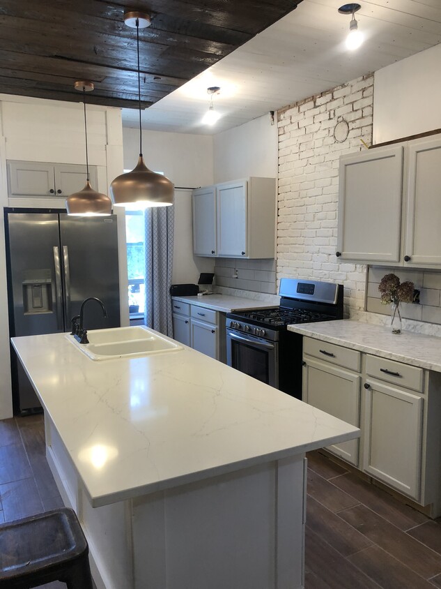 Large, new kitchen with quartz island - 764 Eastern Ave