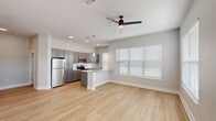 This well-designed single-story residence in Baton Rouge, Louisiana, offers a thoughtfully arranged floor plan with two bedrooms, two full bathrooms, a combined kitchen and living area, a dedicated closet, and an in-unit laundry room. The open-concept kitchen and living space serves as the heart of the home, featuring light wood-look flooring, recessed lighting, and a ceiling fan. The kitchen is outfitted with gray shaker-style cabinetry, stainless steel appliances, a white subway tile backsplash, granite countertops, a peninsula with pendant lighting, and a sink with a modern faucet — all contributing to a clean, contemporary aesthetic. Large windows with blinds allow natural light to fill the living area.

The bedrooms feature neutral carpet, ceiling fans, and windows that bring in additional natural light. The primary bedroom connects to a walk-in closet with wire shelving for organized storage. Both bathrooms are finished with gray vanity cabinetry, granite countertops, framed mirrors, and hardwood-style flooring. The dedicated laundry room accommodates a full-size washer and dryer. Throughout, the consistent use of soft gray tones, white trim, and modern hardware creates a cohesive, move-in-ready environment.