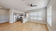 This well-designed single-story residence in Baton Rouge, Louisiana, offers a thoughtfully arranged floor plan with two bedrooms, two full bathrooms, a combined kitchen and living area, a dedicated closet, and an in-unit laundry room. The open-concept kitchen and living space serves as the heart of the home, featuring light wood-look flooring, recessed lighting, and a ceiling fan. The kitchen is outfitted with gray shaker-style cabinetry, stainless steel appliances, a white subway tile backsplash, granite countertops, a peninsula with pendant lighting, and a sink with a modern faucet — all contributing to a clean, contemporary aesthetic. Large windows with blinds allow natural light to fill the living area.

The bedrooms feature neutral carpet, ceiling fans, and windows that bring in additional natural light. The primary bedroom connects to a walk-in closet with wire shelving for organized storage. Both bathrooms are finished with gray vanity cabinetry, granite countertops, framed mirrors, and hardwood-style flooring. The dedicated laundry room accommodates a full-size washer and dryer. Throughout, the consistent use of soft gray tones, white trim, and modern hardware creates a cohesive, move-in-ready environment.