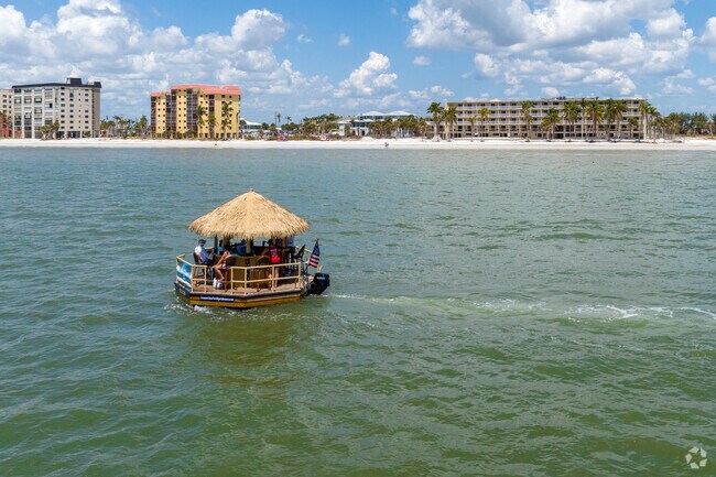 A floating tiki barge bobs off the coast.