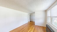 Located at 1310 Nottingham Way in Hamilton, NJ, this single-floor, one-bedroom, one-bathroom unit offers an efficient and well-organized layout. Warm hardwood flooring flows throughout the living room, bedroom, and connecting spaces, lending a classic, timeless character to the interior. The living room is open and inviting, featuring crisp white walls, a textured ceiling, and a cast-iron radiator that adds a touch of vintage charm. Natural light enters through double-pane windows, brightening the space throughout the day. The bedroom is a comfortable size, featuring hardwood floors, closet access, and additional natural light from a window with neighborhood views. The kitchen is a galley-style space appointed with wood cabinetry, white subway tile backsplash, a stainless steel sink, and black appliances including a gas range and refrigerator. Tile flooring and a window overlooking the outdoors make it a practical and pleasant cooking area. The bathroom is clean and bright, finished with white tile flooring, a full tub-shower combination, a vanity, and a window that allows for natural ventilation. Throughout the unit, classic six-panel doors and consistent finishes tie the overall design together cohesively.