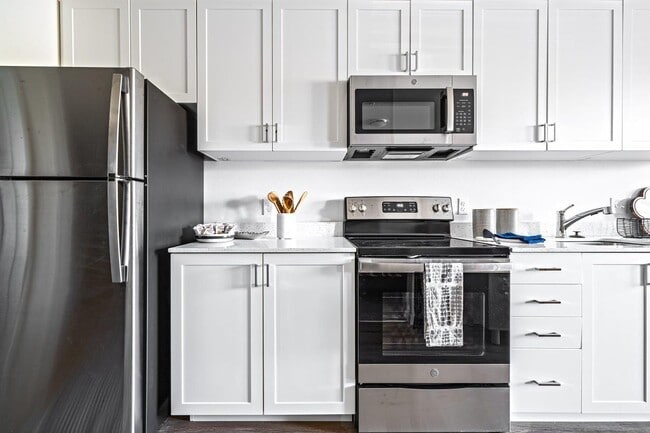 Bright kitchens featuring stainless steel appliances - The Eddy