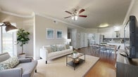 This single-floor, 4-bedroom, 2-bathroom home offers a thoughtfully designed layout that maximizes functionality and comfort. The open-concept living and dining area serves as the heart of the home, featuring warm hardwood-style flooring, crown molding, and ceiling fans throughout. Large windows allow natural light to fill the space, creating a bright and welcoming ambiance.

The kitchen is well-equipped with stainless steel appliances, white cabinetry, granite countertops, a gray tile backsplash, and a central island that doubles as a breakfast bar — seamlessly connecting to the dining area. A dedicated laundry area with a washer and additional storage is conveniently accessible from the kitchen.

The primary bedroom offers a comfortable, carpeted retreat with a closet featuring built-in shelving. Additional bedrooms are similarly appointed with carpeted floors, natural light from windows, and closet access. The bathrooms are clean and functional, with white cabinetry, a single vanity, a tub-shower combination, and overhead storage. A hallway connects the private bedroom wing to the main living areas, and a dedicated closet provides additional storage throughout the home.