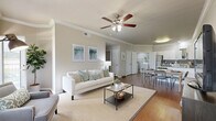 This single-floor, 4-bedroom, 2-bathroom home offers a thoughtfully designed layout that maximizes functionality and comfort. The open-concept living and dining area serves as the heart of the home, featuring warm hardwood-style flooring, crown molding, and ceiling fans throughout. Large windows allow natural light to fill the space, creating a bright and welcoming ambiance.

The kitchen is well-equipped with stainless steel appliances, white cabinetry, granite countertops, a gray tile backsplash, and a central island that doubles as a breakfast bar — seamlessly connecting to the dining area. A dedicated laundry area with a washer and additional storage is conveniently accessible from the kitchen.

The primary bedroom offers a comfortable, carpeted retreat with a closet featuring built-in shelving. Additional bedrooms are similarly appointed with carpeted floors, natural light from windows, and closet access. The bathrooms are clean and functional, with white cabinetry, a single vanity, a tub-shower combination, and overhead storage. A hallway connects the private bedroom wing to the main living areas, and a dedicated closet provides additional storage throughout the home.