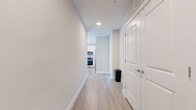 Located at 7350 Honore Avenue in Sarasota, FL, this thoughtfully designed 2-bedroom, 2-bathroom residence offers a clean, modern aesthetic throughout its single-floor layout. Light wood-style flooring flows seamlessly across every room, complementing a neutral color palette of soft whites and warm beiges that creates a bright, airy atmosphere.

The open-concept kitchen and living area serves as the heart of the home. The kitchen is outfitted with stainless steel appliances — including a side-by-side refrigerator with ice maker, electric range, and over-the-range microwave — paired with light wood cabinetry and granite-style countertops. The adjacent living room benefits from large windows and a glass balcony door that invites abundant natural light and leads to a private outdoor balcony.

Both bedrooms are well-proportioned and finished with the same consistent flooring and neutral tones. The primary bedroom is generously sized and connects to an en-suite bathroom featuring a granite vanity, wood-toned cabinetry, and a walk-in closet. The second bathroom offers a tiled tub-shower combination with grab bars, a granite vanity, and hardwood-style flooring.

Additional conveniences include a dedicated laundry area, two hallways providing smooth traffic flow, and two closets for ample storage throughout.