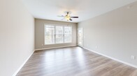 Located at 150 Fieldstone Lane in Daleville, Virginia, this 2-bedroom, 2-bathroom residence offers a functional and comfortable single-floor layout. The open-concept living area features warm wood-look luxury vinyl plank flooring and a ceiling fan, with large windows that invite an abundance of natural light and views of the surrounding neighborhood. The adjacent kitchen is well-equipped with rich warm-toned wood cabinetry, white quartz countertops, stainless steel appliances including a refrigerator, range, over-the-range microwave, and dishwasher, as well as pendant lighting over the countertop bar area. The primary bedroom is generously sized with soft carpeting, a ceiling fan, and two dedicated closets offering ample storage. The second bedroom also features plush carpeting, a ceiling fan, and a large window that brightens the room. Both bathrooms are finished with clean, white tub-shower combinations, tile flooring, and neutral wall tones that create a crisp, functional atmosphere. A neutral color palette throughout the home provides a versatile backdrop for any interior style. Two closets further enhance storage capacity, making this a highly practical and comfortable residence.