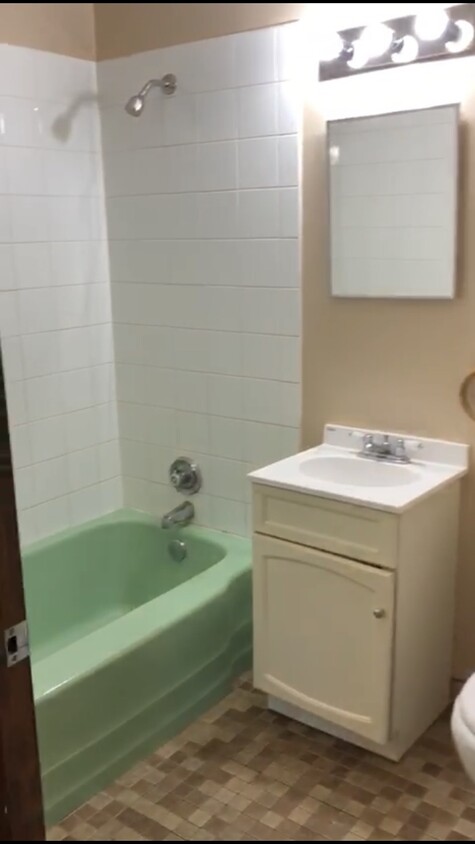 Refreshed bathroom. Example of bathroom in our 2 bedroom units. - 1338 East 7th St