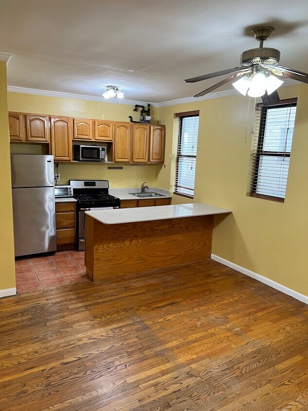 Kitchen with storage, stainless steel appliances, granite counter/bar that fits stools - 2115 33rd St