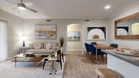 Located at 3100 Van Buren Blvd in Riverside, CA, this single-floor residence offers a thoughtfully designed layout across two bedrooms, one bathroom, a combined living, dining, and kitchen area, a hallway, and an in-unit laundry room. Light wood-style flooring runs throughout the main living areas, creating a cohesive and modern aesthetic. The open-concept living and dining space is bright and welcoming, featuring crown molding, recessed lighting, a ceiling fan, and large sliding glass doors that invite abundant natural light and provide access to an outdoor patio. The kitchen is outfitted with white shaker cabinetry, grey quartz countertops, stainless steel appliances, and a deep sink, offering both style and practicality. The dining area comfortably accommodates a full table and is accented by a large wood-framed mirror. Both bedrooms are carpeted and generously sized, with wide windows that fill the rooms with natural light. The primary bedroom features direct access to the full bathroom. The bathroom includes a single-sink vanity with grey quartz countertops, white cabinetry, a full-size tub and shower combo, and wood-style flooring. Neutral tones throughout lend the space a calm, contemporary ambiance.