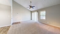 Located at 600 Old Holcomb Bridge Road in Roswell, GA, this 2-bedroom, 2-bathroom single-floor residence offers a well-designed layout across a comfortable footprint. The living room makes a strong first impression with soaring vaulted ceilings, a ceiling fan, and a striking teal accent wall that adds a pop of character to the space. Soft carpet flooring flows throughout the living areas and bedrooms, while wood-look flooring anchors the kitchen and dining areas.

The kitchen features warm oak cabinetry, dark granite-style countertops, a double stainless steel sink, and a stainless steel dishwasher. An adjacent dining area is finished with light hardwood-style flooring and an elegant multi-pendant chandelier. The layout flows conveniently from kitchen to dining to living, making the space ideal for everyday use and entertaining.

The spacious primary bedroom includes vaulted ceilings, a ceiling fan, a sliding glass door with outdoor access, and a window that brings in natural light. The second bedroom is well-sized with plush carpeting and a closet. Both bathrooms are appointed with wood-toned vanities, dark countertops, and tub-shower combinations with wood-look tile flooring. A dedicated laundry room with washer/dryer hookups adds everyday convenience. A covered entry porch completes the home.