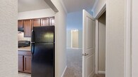 Located at 6200 Habitat Dr in Boulder, CO, this single-floor, one-bedroom, one-bathroom residence offers a well-organized layout with a comfortable and functional living environment. Crown molding is a consistent architectural detail found throughout the home, adding a refined touch to each room.

The living room is generously sized, featuring plush wall-to-wall carpeting, neutral warm-toned walls, and large sliding glass doors with vertical blinds that invite natural light and provide outdoor views. Adjacent to the living room, the dining area flows naturally within the open layout, connecting seamlessly to the rest of the home.

The kitchen is a galley-style space outfitted with rich dark wood cabinetry, stone-toned countertops, tile flooring, and black appliances including a refrigerator, range, and dishwasher. Ample upper and lower cabinet storage makes it highly practical.

The spacious primary bedroom continues the carpeted flooring and neutral palette, benefiting from natural light through large windows. Three closets provide excellent storage throughout the home.

The bathroom features a wood-toned vanity with a stone-finish countertop, a single sink, a full tub-shower combo, and tile flooring. A utility room and two hallways round out the home's well-planned interior, completing a practical and comfortable living space.
