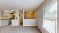 Located at 1616 W Oak St in Denton, Texas, this single-floor unit offers a practical and efficiently designed layout. The living area is finished with neutral-toned carpet and light hardwood-style flooring, creating a warm and cohesive feel throughout the space. Warm beige walls and a ceiling fan contribute to a comfortable, lived-in ambiance, while windows fitted with blinds allow for natural light to filter in and brighten the interior.

The kitchen is compact yet functional, featuring white appliances including a range, and is complemented by granite-style countertops that add a touch of refinement. Built-in shelving near the kitchen provides additional storage and organizational convenience.

The unit includes two bathrooms, one of which features a full shower-tub combination with clean white finishes and light wood-style flooring — maintaining the consistent aesthetic found throughout the space. A dedicated closet area with built-in drawer storage and overhead shelving offers well-organized storage solutions.

The overall design is clean and straightforward, with white trim and doors providing crisp contrast against the neutral walls. This unit at 1616 W Oak St is well-suited for those seeking a no-frills, functional living space in Denton, TX.