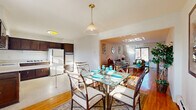 Located at 98 Cedar Ln in Highland Park, NJ, this well-appointed one-bedroom, one-bathroom residence offers a thoughtfully designed single-floor layout. Warm hardwood flooring flows throughout the main living areas, creating a cohesive and inviting atmosphere. The open-concept dining room connects seamlessly to the kitchen and living room, anchored by a glass-top dining table beneath an elegant brass pendant light. Natural light pours in through large windows, enhancing the bright, airy feel. The kitchen features dark wood cabinetry, ample counter space, a gas cooktop, dishwasher, and a window above the sink. The living room provides a comfortable retreat with a welcoming layout and access to a private balcony. The bedroom offers peaceful outdoor views through a large window, hardwood floors, and the convenience of two closets. Four closets total are distributed throughout the residence, providing exceptional storage. The full bathroom includes a tub-shower combo, mosaic tile flooring, a vanity with marble-style countertop, navy tile accents, and an in-unit washer, adding everyday practicality to this well-rounded Highland Park home.