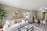 Located at 1201 Harvey Rd in College Station, TX, this two-bedroom, one-bathroom single-story residence offers a functional and thoughtfully laid-out floor plan. The combined living and dining area serves as the heart of the home, featuring wood-style flooring, neutral gray-toned walls, and a textured ceiling that add warmth and cohesion throughout. A large window in the living room frames an outdoor view and draws in generous natural light, creating an inviting atmosphere. The kitchen is efficiently designed with granite-patterned countertops, white cabinetry, and includes a pantry for additional storage. It also provides access to a secondary entry door. The primary bedroom is a comfortable retreat featuring a ceiling fan, a large window with outdoor views, and ample closet space. The second bedroom similarly includes a ceiling fan, closet, and natural light. The full bathroom is equipped with a tub-shower combination. With four closets distributed throughout the home and a dedicated hallway connecting the rooms, storage and flow are well-considered. The consistent use of wood-style flooring and soft neutral tones across all rooms lends the space a cohesive, modern aesthetic suitable for everyday living.
