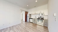 Located at 815 Kinnear Rd. in Columbus, Ohio, this one-bedroom, one-bathroom unit offers a well-designed layout making smart use of its compact footprint. Light-toned luxury vinyl plank flooring runs throughout, creating a cohesive and clean aesthetic across every room.

The open living area is bathed in natural light from large windows fitted with blinds, and crisp white walls enhance the bright, airy feel of the space. A standout design feature is the rustic dark wood sliding barn door, which adds a striking contrast to the otherwise modern, neutral palette.

The kitchen is efficiently appointed with two-tone cabinetry — white uppers paired with grey lowers — complemented by a hexagonal tile backsplash and a full suite of stainless steel appliances, including a refrigerator, gas range, microwave, and dishwasher.

The bedroom is a calm, well-proportioned retreat featuring a large window that allows ample natural light and outdoor views. A dedicated closet provides organized storage. The bathroom includes a white vanity with granite-style countertop, a tub/shower combination, and wood-tone flooring that ties the space together.

Overall, the unit presents a modern, functional design with thoughtful finishes throughout, ideal for those seeking a streamlined living space in Columbus.
