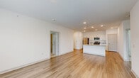 Located at 6857 Poetry Pl in Greenfield, Indiana, this single-story home offers four bedrooms, two bathrooms, and a well-designed layout across a comfortable footprint. The open-concept living and kitchen area serves as the heart of the home, featuring light wood-look flooring, recessed lighting, and a clean, modern aesthetic with crisp white walls throughout. The kitchen is equipped with white shaker-style cabinetry, granite-look countertops, stainless steel appliances including a refrigerator, range, and microwave, and a central island with a sink — ideal for both cooking and entertaining. A set of French doors in the living area invites natural light and provides access to an outdoor space. The four bedrooms are generously proportioned, with the primary bedroom offering a dedicated walk-in closet featuring wire shelving for organized storage. Bedrooms include plush carpeting and windows with blinds that allow for natural light and outdoor views. The two bathrooms are finished with wood-look tile flooring and tub-shower combinations with brushed nickel fixtures. A dedicated laundry room houses a full-size washer and dryer with overhead shelving. Two closets provide additional storage throughout the home.