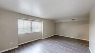Located at 777 Roanoke Blvd in Salem, VA, this one-bedroom, one-bathroom unit offers a well-designed single-floor layout. Consistent wood-style flooring runs throughout the space, complementing the neutral beige walls and white trim that create a clean, cohesive aesthetic.

The living room is a generously sized area bathed in natural light through a large window with blinds. The space connects openly to the rest of the unit, providing a comfortable and versatile area for everyday living.

The kitchen is thoughtfully equipped with warm honey-toned wood cabinetry, granite-patterned countertops, a stainless steel gas range, a stainless steel refrigerator, and a double-basin sink. Light wood-style flooring ties the kitchen seamlessly to the rest of the unit.

The bedroom is bright and well-proportioned, featuring two windows that invite abundant natural light and views of surrounding greenery. A ceiling fan with a light fixture adds both comfort and functionality to the room.

The bathroom is efficiently laid out, featuring a glass-door walk-in shower, a toilet, and a white vanity with storage. Wood-style flooring continues here as well, maintaining a consistent look throughout.

Four closets distributed across the unit provide exceptional storage capacity. A hallway connects the rooms, contributing to a practical and well-organized floor plan.