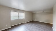 Located at 777 Roanoke Blvd in Salem, VA, this one-bedroom, one-bathroom unit offers a well-designed single-floor layout. Consistent wood-style flooring runs throughout the space, complementing the neutral beige walls and white trim that create a clean, cohesive aesthetic.

The living room is a generously sized area bathed in natural light through a large window with blinds. The space connects openly to the rest of the unit, providing a comfortable and versatile area for everyday living.

The kitchen is thoughtfully equipped with warm honey-toned wood cabinetry, granite-patterned countertops, a stainless steel gas range, a stainless steel refrigerator, and a double-basin sink. Light wood-style flooring ties the kitchen seamlessly to the rest of the unit.

The bedroom is bright and well-proportioned, featuring two windows that invite abundant natural light and views of surrounding greenery. A ceiling fan with a light fixture adds both comfort and functionality to the room.

The bathroom is efficiently laid out, featuring a glass-door walk-in shower, a toilet, and a white vanity with storage. Wood-style flooring continues here as well, maintaining a consistent look throughout.

Four closets distributed across the unit provide exceptional storage capacity. A hallway connects the rooms, contributing to a practical and well-organized floor plan.