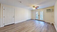 This 660 square foot single-story home in Seabrook, NH, offers a compact yet functional living space. The property features two bedrooms, including a primary bedroom of 170 square feet, and one bathroom. Throughout the home, modern wood-look flooring creates a cohesive and contemporary feel.

The open-concept living area combines the kitchen and living room, maximizing the use of space. The kitchen boasts wooden cabinetry, stainless steel appliances, and a convenient layout. The bathroom features a tiled shower/tub combination with a decorative border, a white vanity, and additional storage.

Both bedrooms are equipped with ceiling fans for comfort and have ample natural light from windows. One room offers direct access to a balcony through French doors, providing an outdoor extension to the living space.

The property's efficient design includes a hallway for easy navigation between rooms. Baseboard heating ensures comfort during colder months. The neutral color palette throughout allows for personalization, while the clean lines and updated fixtures give the home a fresh, modern appearance.

This property at 47 Weare Rd is ideal for those seeking a low-maintenance living option or an investment opportunity in the Seabrook area.