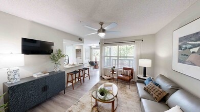 Cozy Living Room with Quartz Countertops and Stainless Steel Appliances - 1250 West Apartments