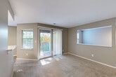 This well-appointed one-bedroom, one-bathroom residence at 4685 Hunt Club Dr in Ypsilanti, Michigan offers a thoughtfully designed single-floor layout with a diverse mix of functional spaces. The open living and dining areas are carpeted and bathed in natural light, courtesy of multiple windows and a sliding glass door that leads to a private balcony with outdoor views of surrounding greenery. A built-in pass-through window connects the living area to the adjacent space, adding an architectural detail that enhances the open feel of the floor plan. The kitchen is a standout feature, showcasing white cabinetry, light stone countertops with a double sink, stainless steel appliances, and light wood-style flooring that runs throughout the cooking and utility areas. A dedicated office provides a quiet, separate workspace within the home. The carpeted bedroom receives ample natural light through a window with views of the tree line, and offers access to closet storage. The bathroom is equipped with a full tub-shower combination, tiled surround, and chrome fixtures. Additional conveniences include a utility room, hallway, and two closets, ensuring practical storage throughout. Neutral tones and clean finishes give the entire space a versatile, move-in-ready character.