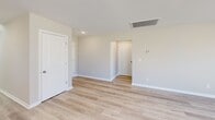 This contemporary two-story residence in Hazel Green, Alabama, offers 1630 square feet of living space, thoughtfully distributed across four bedrooms and five bathrooms. The ground floor, spanning 1180 square feet, houses the main living areas, including a sleek kitchen with white cabinetry, granite countertops, and stainless steel appliances. An adjoining open-concept living room enhances the sense of space.

The home's design prioritizes functionality, featuring a dedicated laundry room and a spacious garage with ample storage potential. The upper level, comprising 440 square feet, accommodates additional bedrooms, including the generous 200-square-foot primary suite.

Throughout the property, neutral tones and light wood-look flooring create a bright, airy ambiance. The bathrooms showcase modern fixtures, including a combination tub-shower unit with a curved shower rod. Large windows in various rooms allow natural light to flood the interiors, while recessed lighting provides supplementary illumination.

Multiple hallways ensure easy navigation between rooms, and the staircase connects the two levels seamlessly. The property's layout, with its balance of private and communal spaces, caters to both family living and entertaining needs.