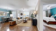 This thoughtfully designed 2-bedroom, 4-bathroom single-floor residence offers a comfortable and functional layout with stylish finishes throughout. Rich hardwood flooring flows through the main living areas, creating a warm and cohesive aesthetic. The open living room is bathed in natural light from multiple large windows dressed with elegant curtains, and features a ceiling fan and neutral-toned walls that lend a bright, airy feel. Adjacent to the living room, the dining area is highlighted by crown molding, a decorative pendant light, and a bold accent wall that adds a touch of personality. The kitchen is well-equipped with rich dark cabinetry, granite countertops, stainless steel appliances, and tile flooring, offering ample storage and workspace. The primary bedroom is generously sized, featuring hardwood floors, a bold teal accent wall, a ceiling fan, and access to a walk-in closet with dual hanging rods and built-in shelving. The second bedroom is equally inviting with hardwood floors and natural light. The four bathrooms are finished with dark wood vanities, granite countertops, and tile flooring. A dedicated hallway connects the rooms, completing this well-organized and comfortable floor plan.