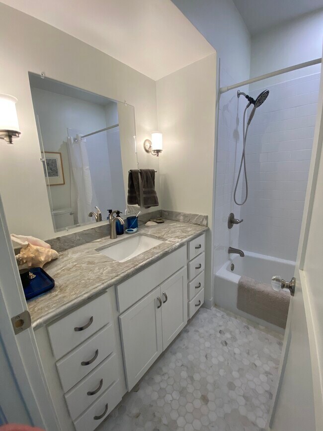 Marble topped vanity in bathroom. Full tub/shower, linen closet in bathroom. - 8 Slocum St