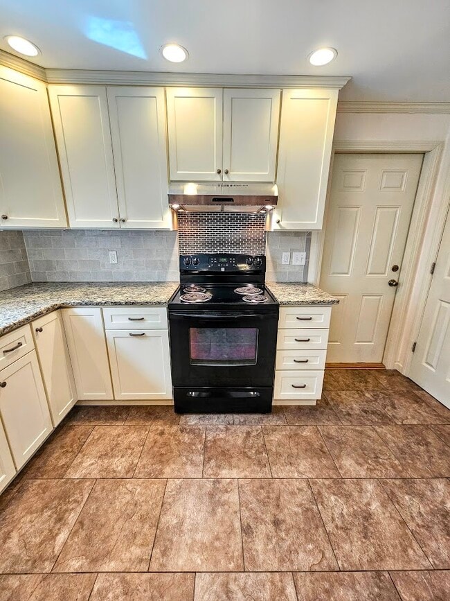 Electri stove with vent fan, and door to garage. Lots of storage. - 30 Fairfield Ave