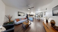 Located at 7017 S Buffalo Dr in Las Vegas, NV, this well-appointed 2-bedroom, 3-bathroom residence offers a thoughtfully designed single-floor layout. The open-concept living and dining area serves as the heart of the home, featuring rich dark hardwood-style flooring, a ceiling fan, and a seamless flow into the kitchen — ideal for both everyday living and entertaining. The kitchen is outfitted with dark espresso cabinetry, white quartz-style countertops, and a full suite of stainless steel appliances, including a refrigerator, range, and built-in microwave. Both bedrooms are generously proportioned, with plush carpeting, ceiling fans, and windows that invite natural light. The primary bedroom offers a comfortable, retreat-like ambiance. Three bathrooms feature clean, light tile flooring, tub-shower combinations, and dark-finish vanities with white countertops, maintaining a consistent modern aesthetic throughout. A dedicated in-unit laundry room houses a full-size washer and dryer. Hallways connect the spaces efficiently, and a closet provides additional storage. The overall design balances contemporary style with functional living, making this a practical and attractive home in the heart of Las Vegas.