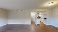 Located at 901 St Johns Wood Dr in Richmond, VA, this single-floor, one-bedroom, one-bathroom residence offers a practical and well-appointed layout. Wood-style flooring flows throughout the entire home, lending a cohesive and contemporary feel to every room.

The living room is generously sized, featuring neutral walls, clean white baseboards, and a large window that fills the space with natural light and views of the surrounding greenery. A hallway with dual entry doors provides a welcoming transition into the home.

The kitchen is efficiently designed in a galley configuration, showcasing white cabinetry, dark granite-style countertops, and stainless steel appliances including a gas range, microwave, and refrigerator. A notable feature is the in-unit washer and dryer, conveniently located within the kitchen area. A rear door with a window offers additional natural light and outdoor access.

The bedroom is a comfortable, well-proportioned retreat with a horizontal window framing outdoor greenery. It features two sets of double-door closets, providing ample storage. The neutral color palette maintains a calm, restful atmosphere.

The bathroom is clean and functional, equipped with a full shower/tub combo, white vanity, and wood-style flooring that ties into the rest of the home. Overall, this residence offers an efficient, move-in-ready living experience.