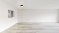 This 2-bedroom, 2-bathroom unit in North Miami Beach presents a clean, modern aesthetic throughout its well-organized single-floor layout. Light wood-style flooring runs consistently across the living areas and bedrooms, lending warmth and visual continuity to the space. The living room is generously proportioned, featuring a sliding glass door that opens to a private balcony with outdoor views, allowing natural light to fill the interior.

The kitchen is efficiently designed with white cabinetry extending to the ceiling, stainless steel appliances including a refrigerator, range, microwave, and dishwasher, and a light countertop surface that complements the overall neutral palette.

Both bedrooms are well-sized with large windows that frame exterior views of the surrounding North Miami Beach neighborhood. The primary bedroom offers a comfortable footprint with dedicated closet access. The two bathrooms contrast in design: one features marble-style tile flooring and a soaking tub with tiled surround, while the other includes a walk-in shower with matching marble-style wall tile and a white vanity. A hallway connects the rooms, ensuring a practical and logical flow throughout the unit.