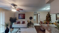 This single-story unit in Houston, Texas offers a functional and comfortable layout across its one-bedroom, one-bathroom floor plan. The living room serves as the central gathering space, featuring crown molding, a ceiling fan with light fixture, and soft carpeting underfoot. A large sliding glass door fitted with vertical blinds allows natural light to fill the room, while a glass-top coffee table and neutral-toned sofa contribute to its inviting atmosphere.

The galley-style kitchen is efficiently designed, featuring white cabinetry, granite-look countertops, a double-basin sink, an electric range, a dishwasher, and a refrigerator. Wood-look flooring runs through the kitchen, adding warmth and practicality to the cooking space.

The bedroom is a calm retreat with plush carpeting, soft gray walls, and blinds-covered windows that provide natural light and privacy. A walk-in closet is accessible directly from the room, offering convenient storage.

The bathroom includes a single vanity with granite-look countertops, a lighted mirror, under-sink cabinetry, wood-look flooring, and a shower/tub combination. The overall design of the unit balances practicality with comfort throughout.