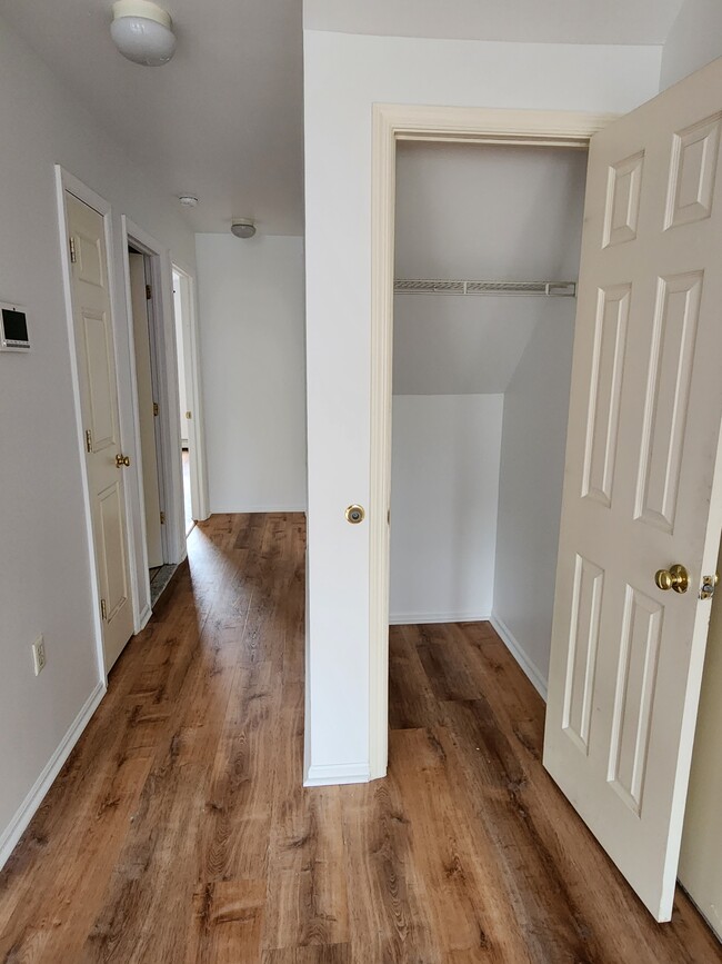 Coat closet (right) with storage and linen closet in hall (left) - 180 S Oxford St