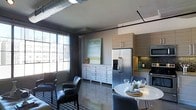 This single-floor space showcases an industrial-chic aesthetic defined by exposed ductwork and piping along the ceiling, contrasting with clean, contemporary finishes throughout. The open-concept layout seamlessly connects the living, dining, and kitchen areas, creating a cohesive and functional environment.

The living area features dark upholstered armchairs arranged on a patterned area rug, anchored by a large window that draws in abundant natural light and offers views of the surrounding urban skyline. A whitewashed multi-drawer dresser serves as a decorative storage piece beneath a soft landscape painting, adding an artistic touch.

The kitchen is outfitted with stainless steel appliances, including a French door refrigerator with an ice and water dispenser and a built-in microwave. Light wood cabinetry pairs with a subway-style mosaic tile backsplash and dark countertops, striking a balance between warm and modern tones.

Adjacent to the kitchen, the dining area accommodates a round white table surrounded by upholstered chairs, creating an intimate setting. The polished concrete-style flooring ties all zones together, reinforcing the loft's urban industrial character throughout.
