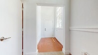Located at 2110 Pickens St in downtown Columbia, SC, this one-bedroom, two-bathroom unit offers a well-organized layout across a single floor. Warm terracotta tile flooring runs throughout the space, lending a distinctive, classic character to every room. The kitchen is outfitted with white shaker cabinetry, granite countertops, a subway tile backsplash, and a full suite of stainless steel appliances including a refrigerator, range, microwave, and dishwasher. A built-in wine rack adds a functional design touch, and an in-unit washer is accessible through a nearby closet. The dining area flows naturally from the kitchen, while a separate living space benefits from tall ceilings and large windows that invite natural light and views of the surrounding brick architecture. The bedroom is a comfortable, private retreat with its own dedicated closet. Both bathrooms are equipped with tub-shower combinations, dark-toned vanity cabinetry, and granite countertops, echoing the consistent material palette found throughout the unit. The clean white walls and bright trim provide a neutral backdrop that complements the warmth of the tile floors and the richness of the darker cabinetry finishes.