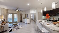 This thoughtfully designed 1-bedroom, 2-bathroom residence offers an efficient and stylish single-floor layout. The open-concept kitchen and living area serves as the heart of the home, featuring a chef-inspired kitchen equipped with dark espresso cabinetry, stainless steel appliances, subway tile backsplash, and a granite-topped island with built-in sink, dishwasher, and seating for casual dining. Pendant lighting illuminates the island, while recessed lighting brightens the full space. The living room flows seamlessly from the kitchen, showcasing light wood-style flooring, a ceiling fan, and floor-to-ceiling sliding glass doors that flood the room with natural light and provide access to an outdoor patio. The primary bedroom offers a comfortable retreat with plush carpeting, a ceiling fan, and large windows that invite natural light. The en-suite bathroom is well-appointed with dark cabinetry, granite countertops, a wide vanity mirror, and direct access to a dedicated walk-in closet. A second full bathroom features a pedestal sink and clean, neutral finishes. Throughout the residence, a consistent neutral color palette and modern fixtures create a cohesive, contemporary ambiance.