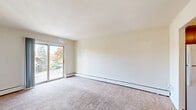 Located at 519 Williams Rd in King of Prussia, PA, this one-bedroom, one-bathroom residence offers a practical and comfortable layout across a single floor. The living room is bright and open, featuring wall-to-wall carpeting, a sliding glass door that fills the space with natural light, and direct access to a private balcony overlooking the tree-lined community grounds. A wall-mounted air conditioning unit and baseboard heating provide year-round climate control. The hallway connects the main living areas and leads to three closets, offering generous storage throughout. The bedroom is a comfortable size, carpeted, and equipped with a window dressed with blinds and its own wall AC unit, ensuring a quiet and climate-controlled retreat. The kitchen is efficiently designed with warm oak cabinetry, tile backsplash, granite-look countertops, and white appliances including a refrigerator, electric range, and dishwasher, all set on durable tile flooring. The bathroom features wood-look flooring, a white vanity with cabinet storage, a lighted medicine cabinet mirror, and clean, neutral finishes. The building is set within a landscaped community with ample parking and mature trees, providing a pleasant residential atmosphere.