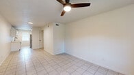 Located at 4309 Scovel Ave in Pascagoula, Mississippi, this single-story 2-bedroom, 2-bathroom home offers a clean, functional layout with consistent finishes throughout. The combined kitchen and living area forms the heart of the home. The galley-style kitchen is well-appointed with white shaker cabinetry featuring matte black hardware, light stone countertops, a black undermount sink, and stainless steel appliances, all set over light tile flooring. The living room extends from the kitchen and is finished with the same tile flooring, a ceiling fan with integrated lighting, and a visible HVAC vent for climate control. The spacious primary bedroom stands out with light wood-look plank flooring, a textured ceiling, and two windows that invite natural light and outdoor views. The second bedroom also features tile flooring, a ceiling fan, and a window overlooking the outdoors. Both bathrooms are neatly finished — one includes a modern vanity with a white countertop, oval mirror, and matte black accents over tile flooring, while the other features a full tub-shower combination with white tile surround. A hallway and closet provide additional storage and circulation throughout the home.