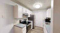 Located at 70002 N Colton St in Spokane, WA, this single-floor unit offers a thoughtfully designed layout with consistent, updated finishes throughout. Wood-look flooring runs continuously across the space, contributing to a cohesive and clean aesthetic, while textured ceilings add visual character to each room.

The living area is generously sized, providing ample room for seating and relaxation. A large sliding glass door floods the space with natural light and opens directly to an outdoor patio, creating a seamless connection to the exterior. A dedicated dining area sits adjacent, offering a practical space for meals.

The kitchen features white shaker-style cabinetry, gray countertops, a tile backsplash, and stainless steel appliances, including an electric range and refrigerator. A closet pantry provides additional storage.

A wide hallway connects the living spaces to the bedrooms, which are well-proportioned and include ample closet space. One bedroom benefits from a window with natural light, while the primary bedroom offers a generous footprint. The bathroom includes a white vanity with a gray countertop, overhead lighting, and a shower-tub combination. The overall ambiance is clean, neutral, and move-in ready.