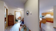 Located at 910 S Oak St in Cloquet, Minnesota, this single-floor residence offers a well-organized layout comprising one bedroom, one bathroom, a combined kitchen and living room, a dedicated office, and a connecting hallway. The kitchen features warm-toned wood cabinetry in an L-shaped configuration with ample storage, white appliances including a dishwasher and electric range, and a breakfast bar that opens toward the dining area — ideal for casual meals. The living room is carpeted and bright, highlighted by a sliding glass door that invites natural light and provides access to an outdoor area. The spacious bedroom includes a large closet with wood-paneled doors, soft carpet flooring, and a window dressed with curtains, creating a comfortable, restful retreat. A separate office space offers flexibility for work or additional storage needs, also featuring a closet. The bathroom is finished with wood-toned cabinetry, a single-sink vanity with a large mirror, and a shower-tub combination. Throughout the home, textured ceilings, neutral wall tones, and durable wood-look flooring in the wet areas lend a consistent, cohesive aesthetic. The hallway connects the rooms efficiently, completing this functional and comfortable single-level layout.