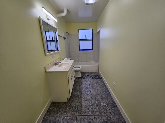 Extra spacious bathroom with granite countertops, Large medicine cabinet and bathtub. - 1030 Aldgate Ave